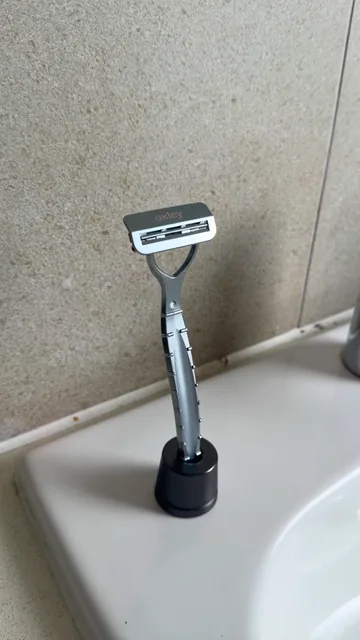 Oxley razor standing upright on a bathroom counter